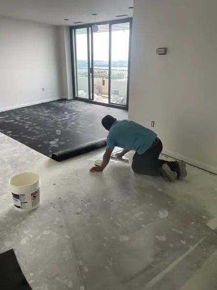 Izquierdo's crew removing old subfloor before a new hardwood installation